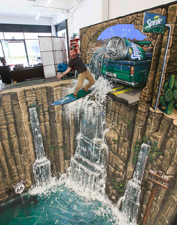 3D-Street-Art-Sprite-Man-Surfing-on-a-Waterfall-Image